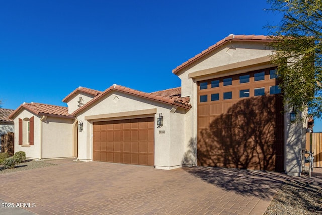 mediterranean / spanish house with a garage