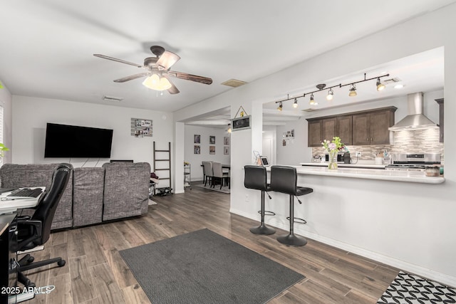 office area with baseboards, ceiling fan, visible vents, and dark wood-type flooring