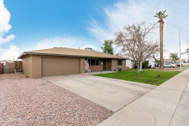 ranch-style house with a garage, driveway, fence, a front yard, and stucco siding