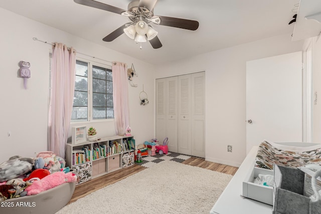 playroom featuring a ceiling fan and light wood-style floors