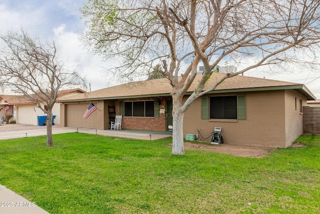 ranch-style house with brick siding, a shingled roof, concrete driveway, a front yard, and a garage