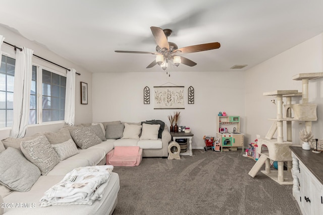 living area with carpet floors, visible vents, and ceiling fan