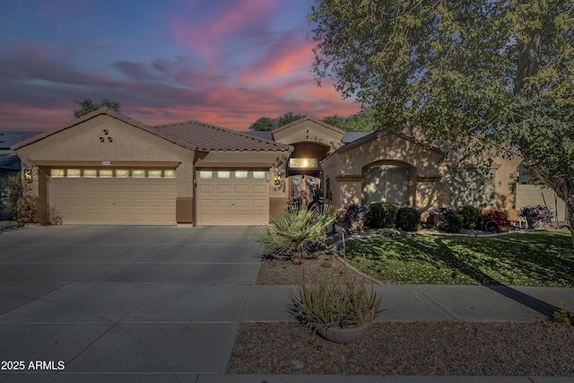 mediterranean / spanish-style home with a garage