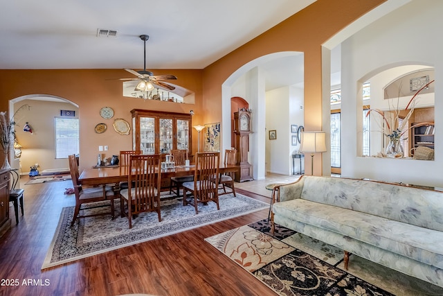 dining space with dark wood-type flooring and ceiling fan