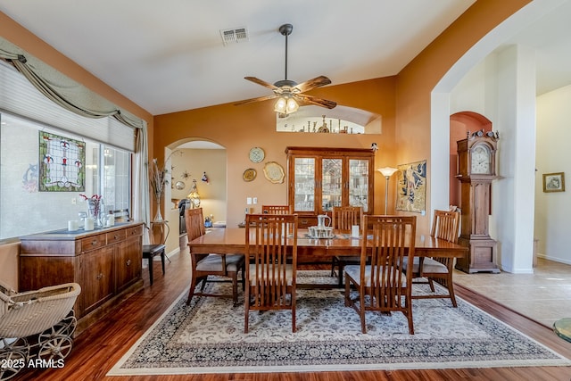 dining area featuring lofted ceiling, dark hardwood / wood-style flooring, and ceiling fan