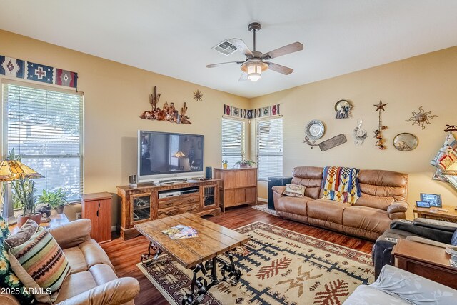 living room with ceiling fan, wood-type flooring, and plenty of natural light