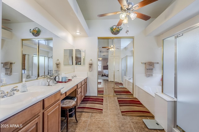 bathroom with shower with separate bathtub, vanity, and tile patterned floors