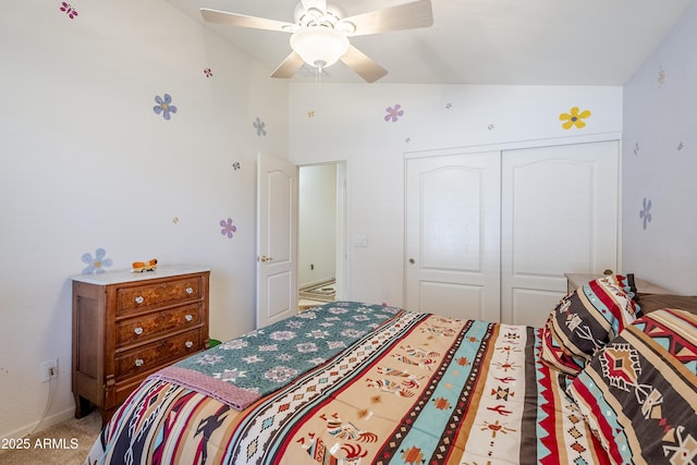 carpeted bedroom featuring vaulted ceiling, ceiling fan, and a closet