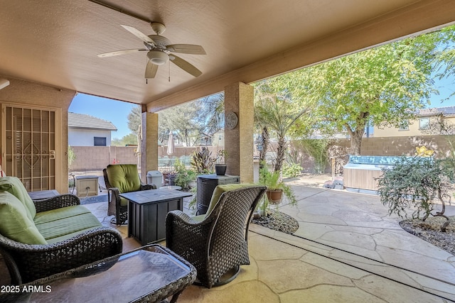 view of patio featuring ceiling fan and a hot tub