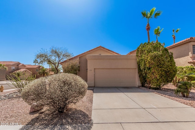 view of front of house with stucco siding, driveway, and an attached garage