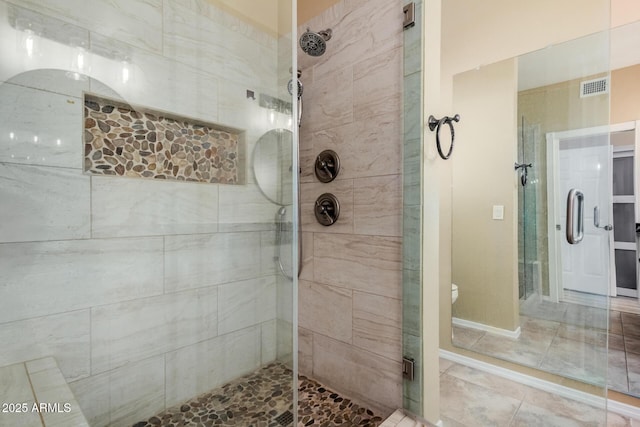 bathroom with visible vents and a shower stall