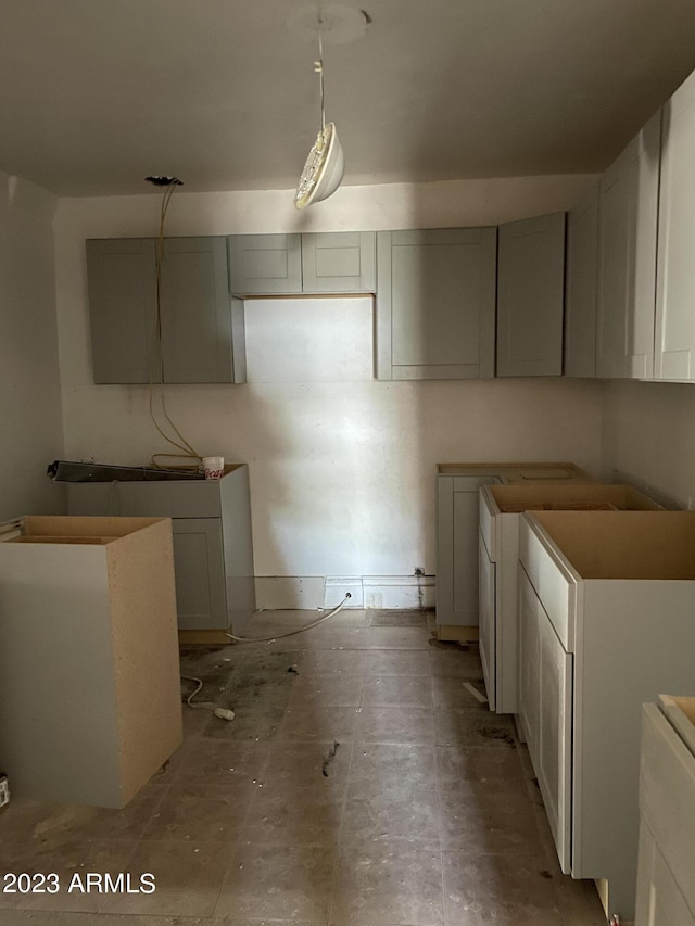 kitchen featuring light tile flooring and gray cabinetry