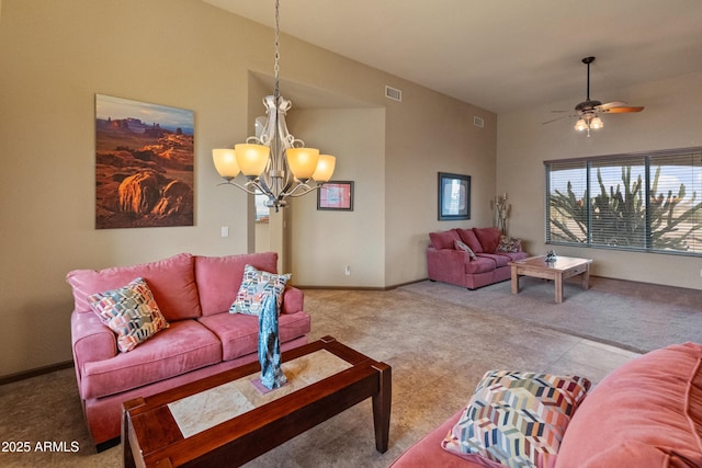 carpeted living room featuring ceiling fan with notable chandelier