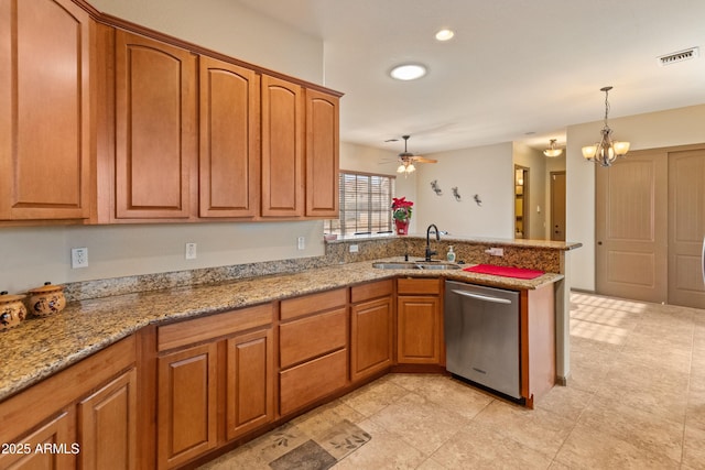 kitchen featuring pendant lighting, sink, stainless steel dishwasher, kitchen peninsula, and light stone countertops