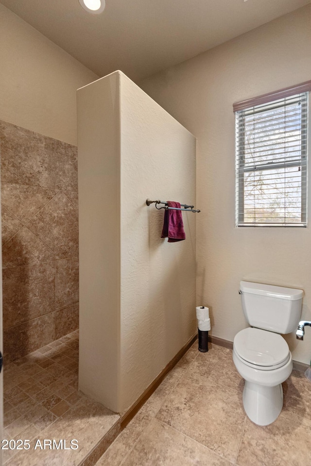 bathroom with walk in shower and toilet