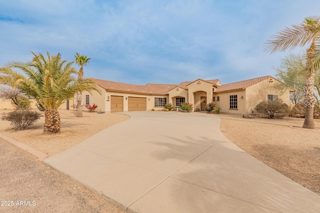 mediterranean / spanish-style house with a garage