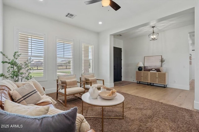 living room with wood finished floors, baseboards, ceiling fan, and recessed lighting