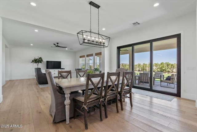 dining area featuring light wood finished floors, recessed lighting, a chandelier, baseboards, and ceiling fan