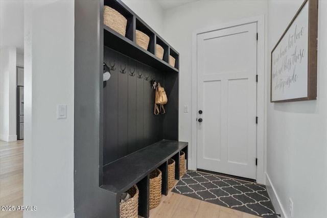 mudroom with wood finished floors and baseboards