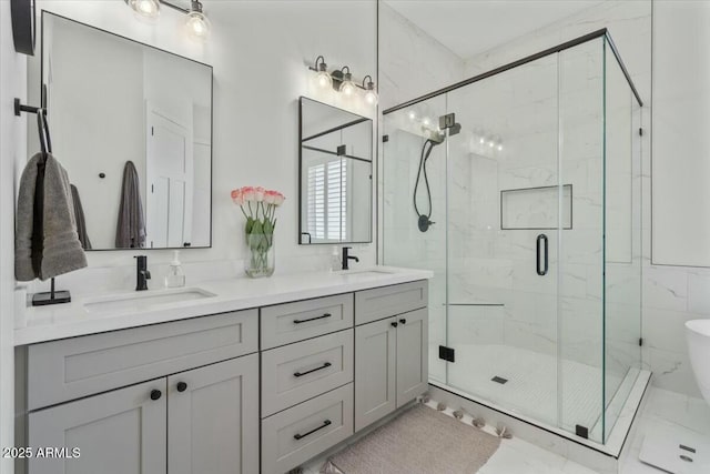 full bathroom with a shower stall, double vanity, and marble finish floors