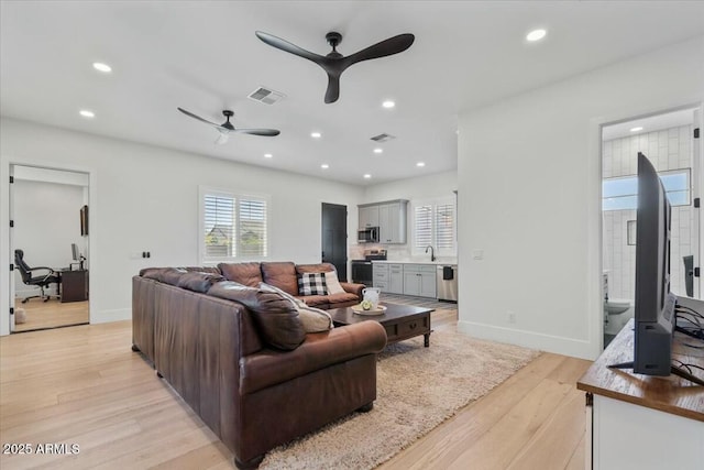 living room with ceiling fan, light wood-style flooring, recessed lighting, baseboards, and an office area