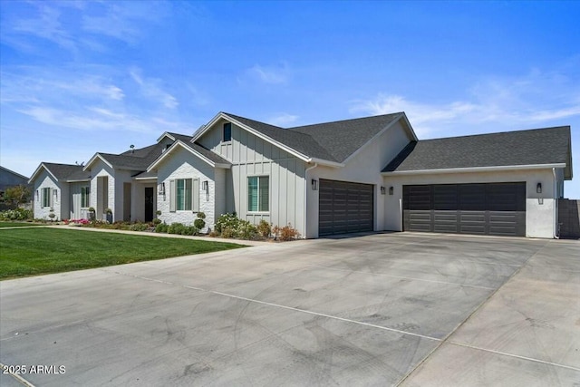 modern farmhouse style home with board and batten siding, an attached garage, concrete driveway, and a front yard