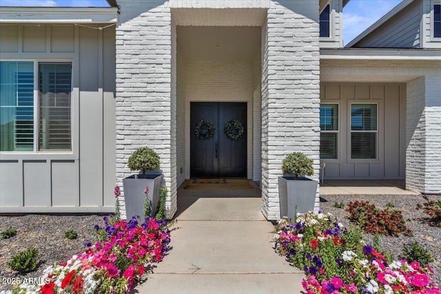 doorway to property featuring board and batten siding