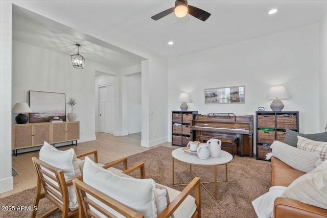 living area featuring ceiling fan, wood finished floors, recessed lighting, and baseboards