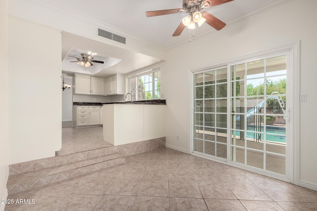 2547 W Naranja Ave, Mesa, AZ 85202 - unfurnished living room featuring a ceiling fan, light tile patterned flooring, crown molding, and a raised ceiling