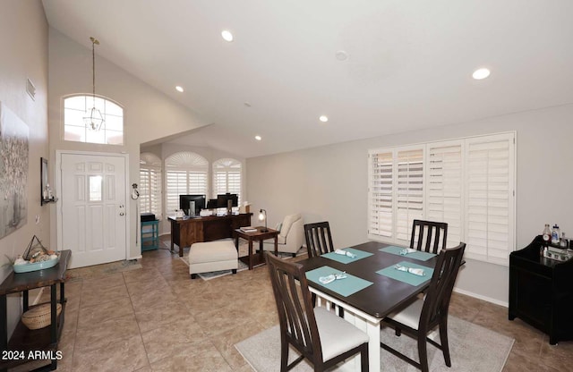 dining room with high vaulted ceiling