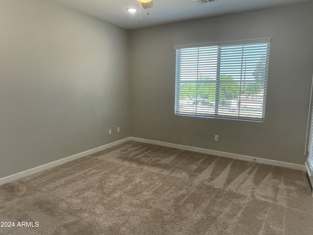 spare room featuring carpet and ceiling fan