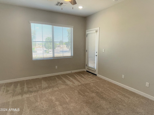 spare room with carpet floors and ceiling fan