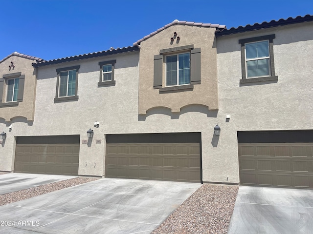 mediterranean / spanish home featuring a garage