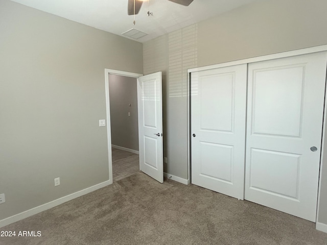 unfurnished bedroom with carpet floors, a closet, and ceiling fan