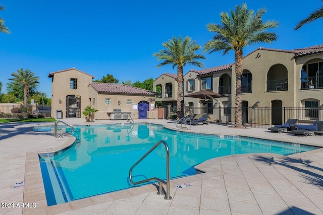 view of pool with a patio and central AC