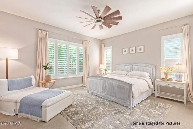 carpeted bedroom with ceiling fan