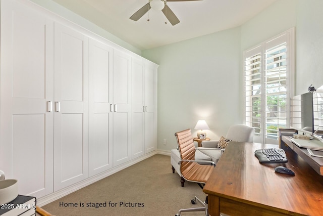 carpeted home office with ceiling fan