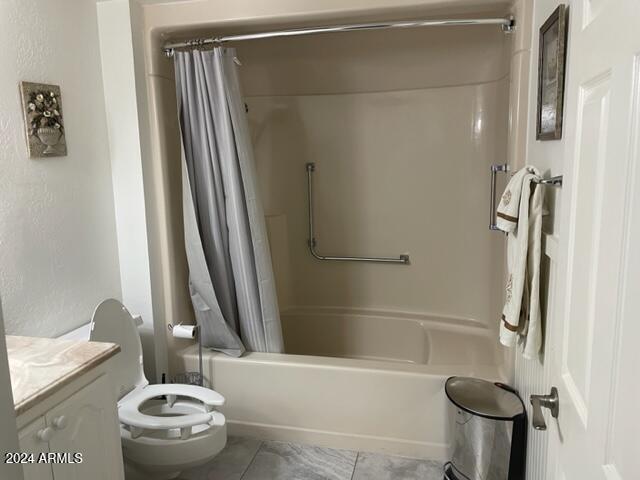 full bathroom with tile patterned flooring, vanity, toilet, and shower / tub combo with curtain