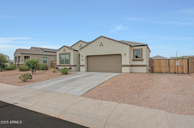 30777 W Whitton Ave, Buckeye, AZ 85396 - mediterranean / spanish home with an attached garage, stucco siding, concrete driveway, a tiled roof, and a gate