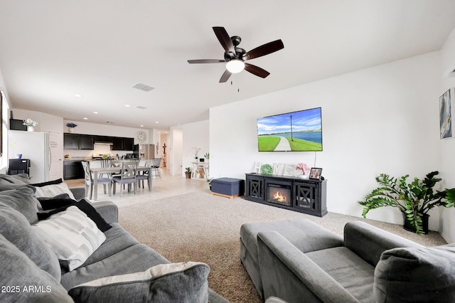 30777 W Whitton Ave, Buckeye, AZ 85396 - living area with a ceiling fan, a glass covered fireplace, and recessed lighting