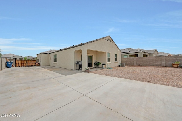 30777 W Whitton Ave, Buckeye, AZ 85396 - back of house featuring a patio, a fenced backyard, stucco siding, and cooling unit