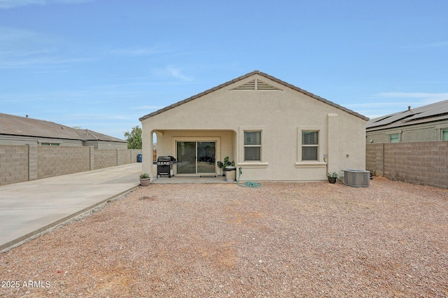 30777 W Whitton Ave, Buckeye, AZ 85396 - back of property featuring a patio area, a fenced backyard, central AC, and stucco siding