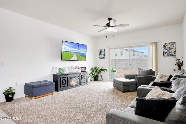 30777 W Whitton Ave, Buckeye, AZ 85396 - living area featuring ceiling fan, carpet, a glass covered fireplace, and baseboards