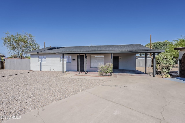 1616 E Pecan Rd, Phoenix, AZ 85040 - view of front of house featuring a carport, concrete driveway, solar panels, covered porch, and roof with shingles
