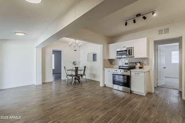 1616 E Pecan Rd, Phoenix, AZ 85040 - kitchen featuring stainless steel appliances, light countertops, a chandelier, dark wood-style flooring, and white cabinets
