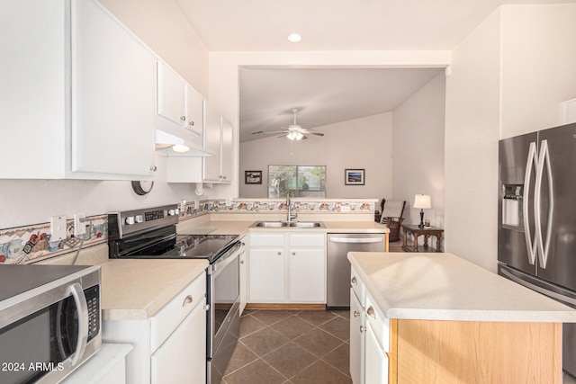 kitchen featuring sink, lofted ceiling, a center island with sink, white cabinets, and appliances with stainless steel finishes