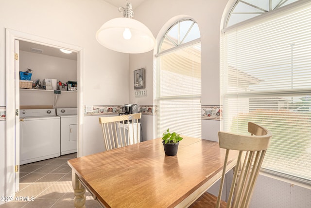 dining area with light tile patterned floors and washing machine and dryer