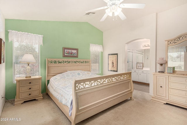 bedroom with light carpet, vaulted ceiling, and ceiling fan