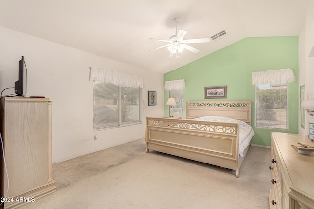 bedroom with light colored carpet, vaulted ceiling, and ceiling fan