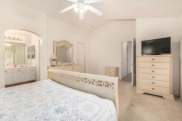 carpeted bedroom featuring connected bathroom, ceiling fan, and vaulted ceiling